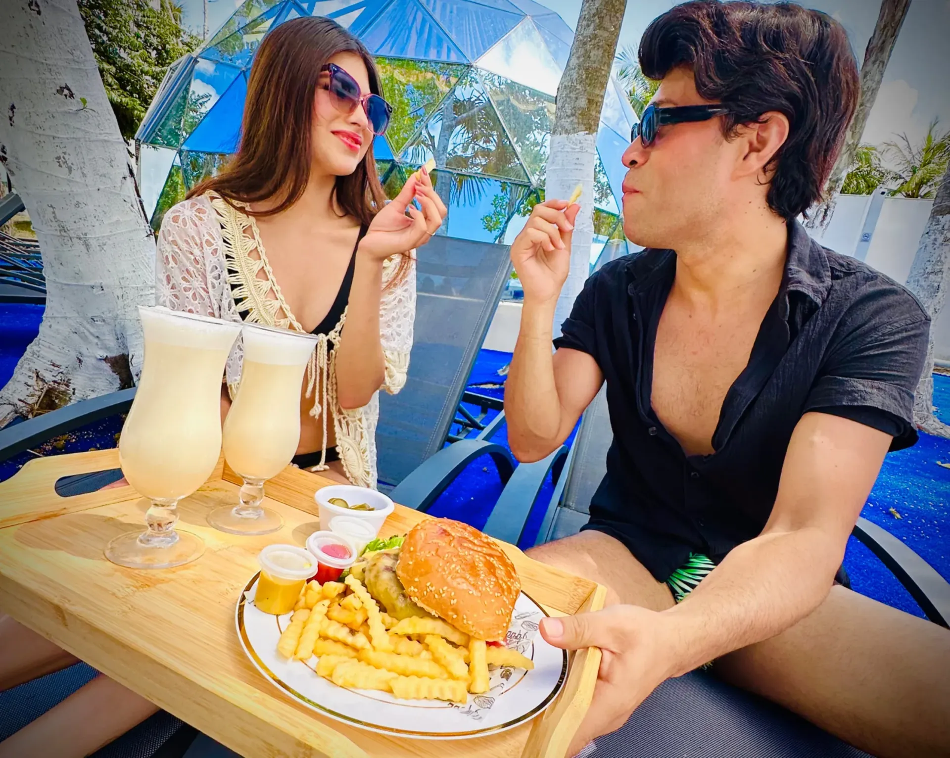 Una larga mesa de madera con platos y vasos encima.