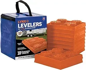 Orange Lynx levelers in a blue carrying bag, for leveling RVs.
