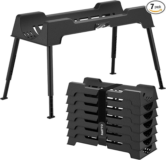 Black sawhorse with adjustable legs and a stack of six similar supports bound with a strap.