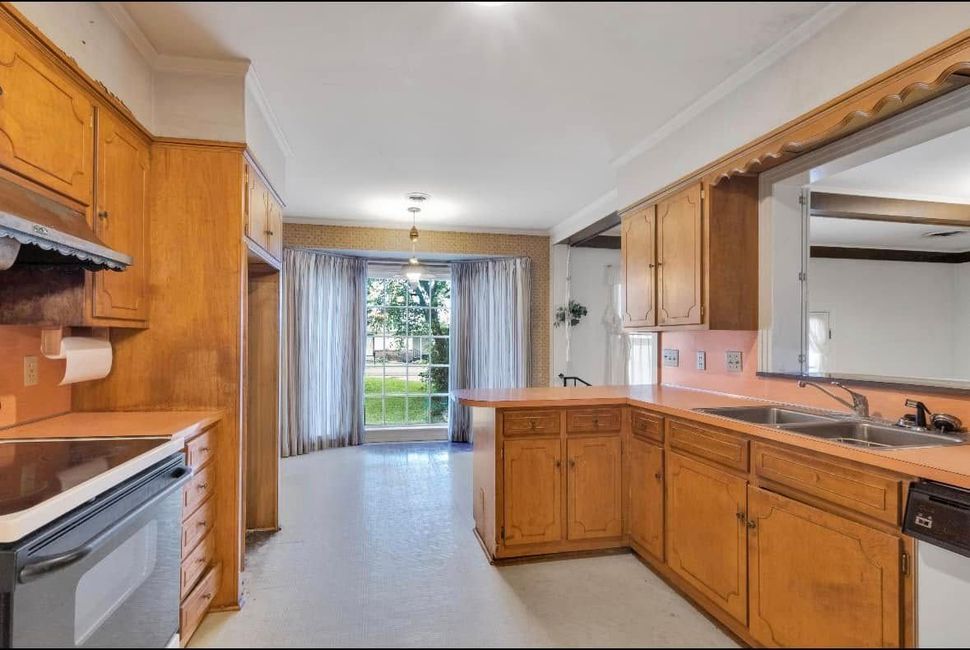 A kitchen with wooden cabinets and stainless steel appliances