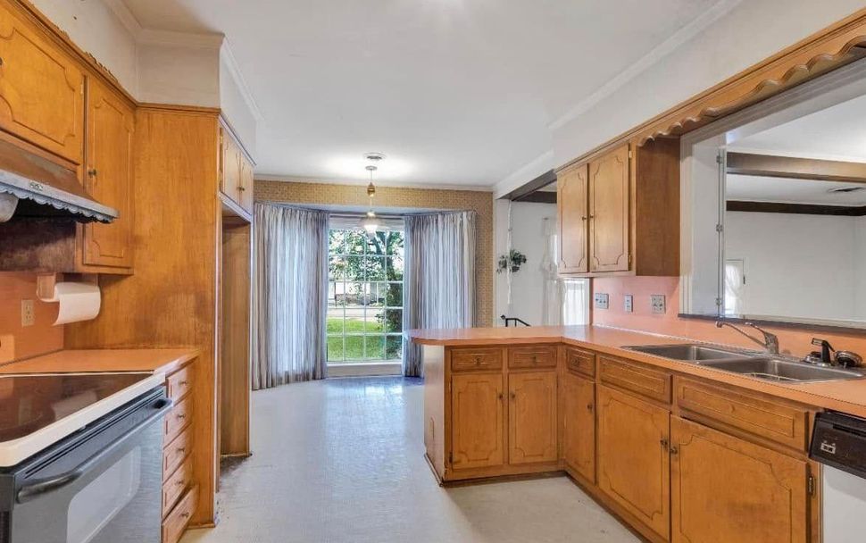 A kitchen with wooden cabinets and stainless steel appliances