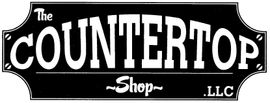 A black and white sign for the A black and white sign for the The Countertop Shop 