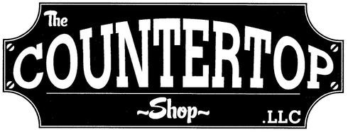 A black and white sign for the The Countertop Shop 