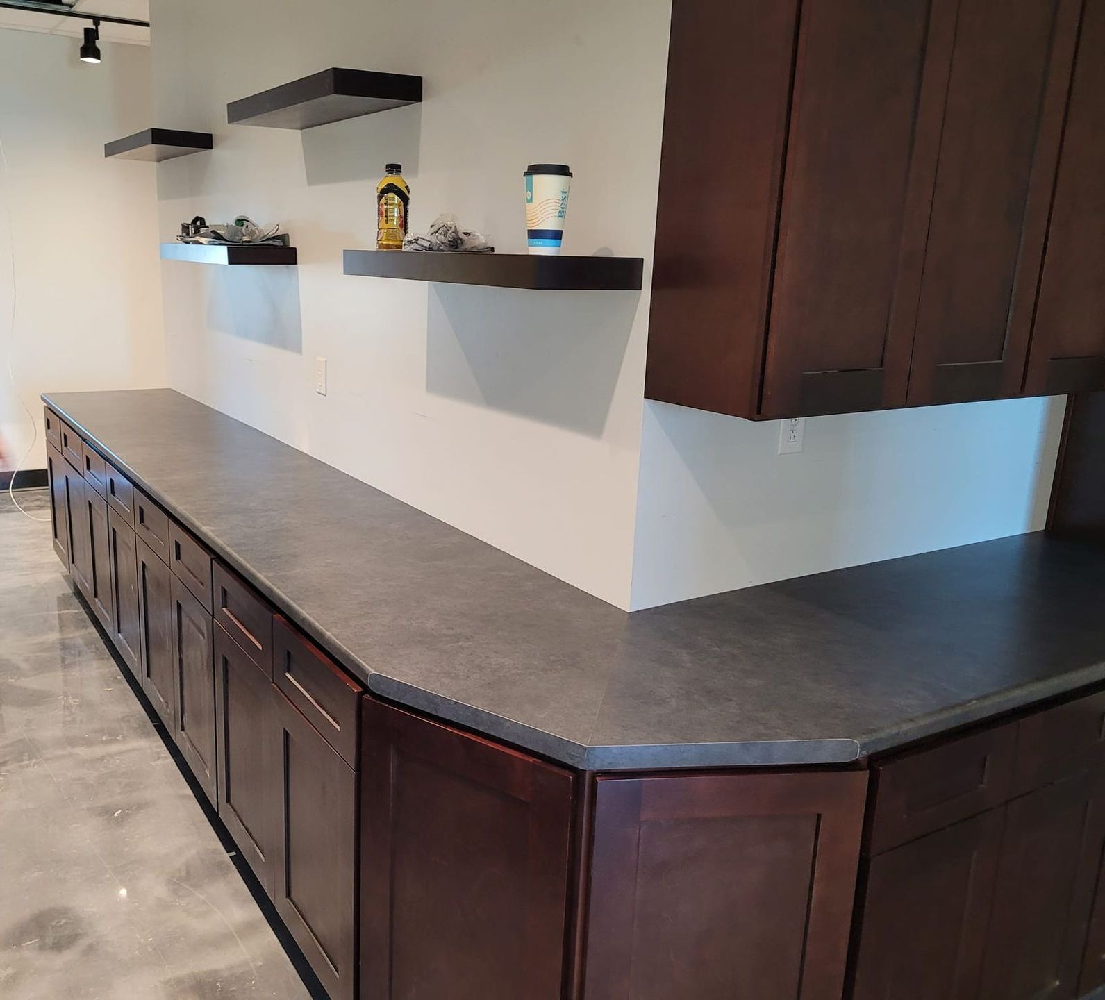 A kitchen with wooden cabinets and a gray counter top