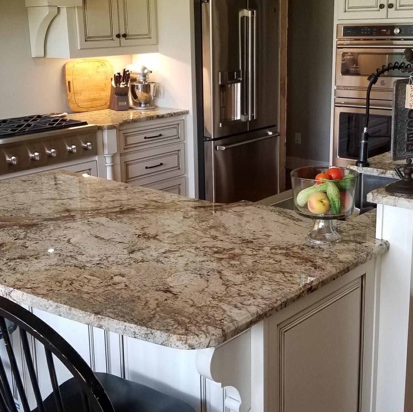 A kitchen with granite counter tops and stainless steel appliances