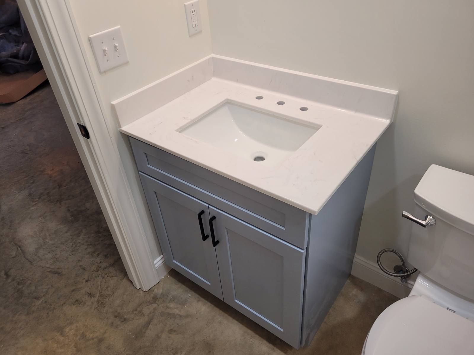 A bathroom with a sink and a toilet.