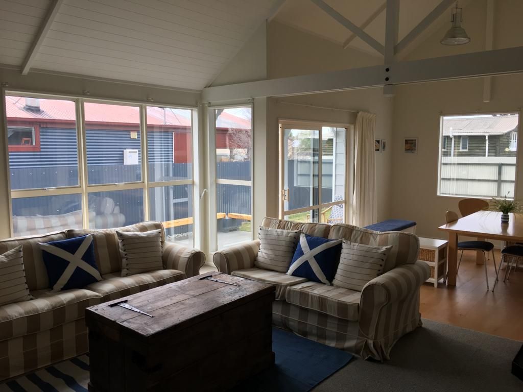 A living room with a striped couch - Christchurch, NZ - Tint A Window