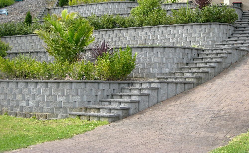 A brick wall with stairs leading up to a house.