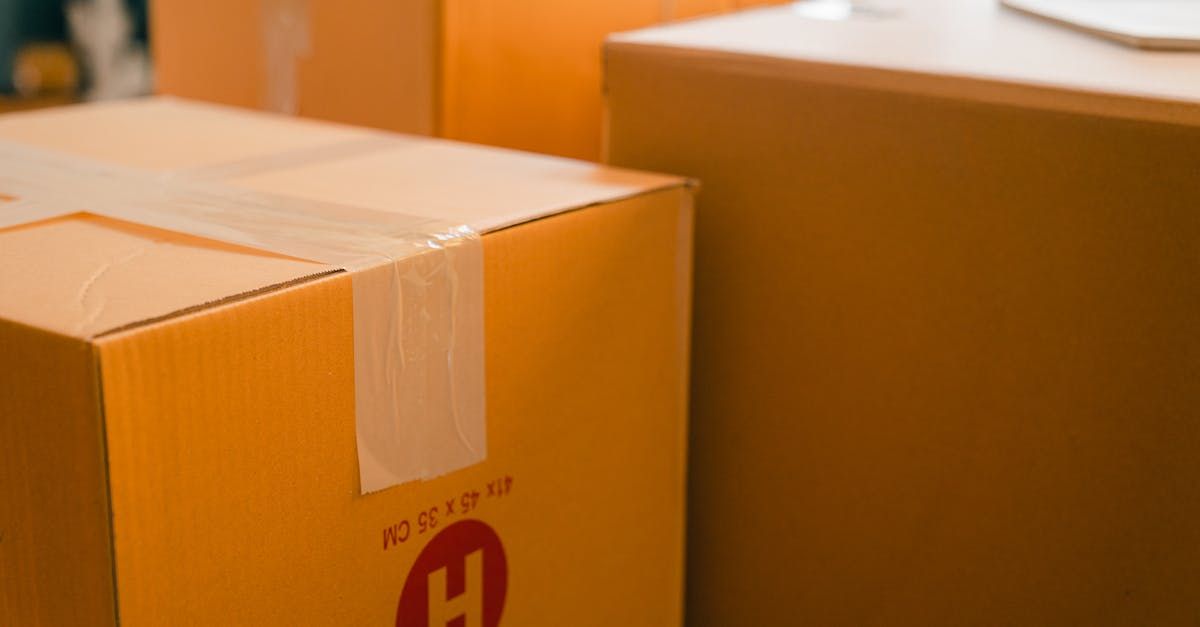 Two cardboard boxes are sitting on top of each other on a table.