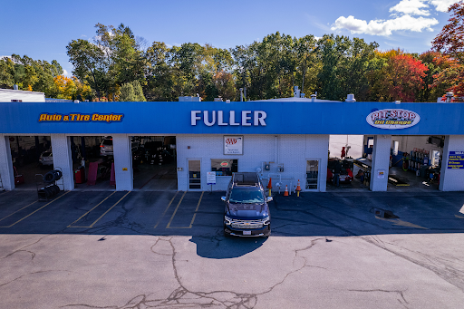 An aerial view of a fuller tire shop with a car parked in front of it.