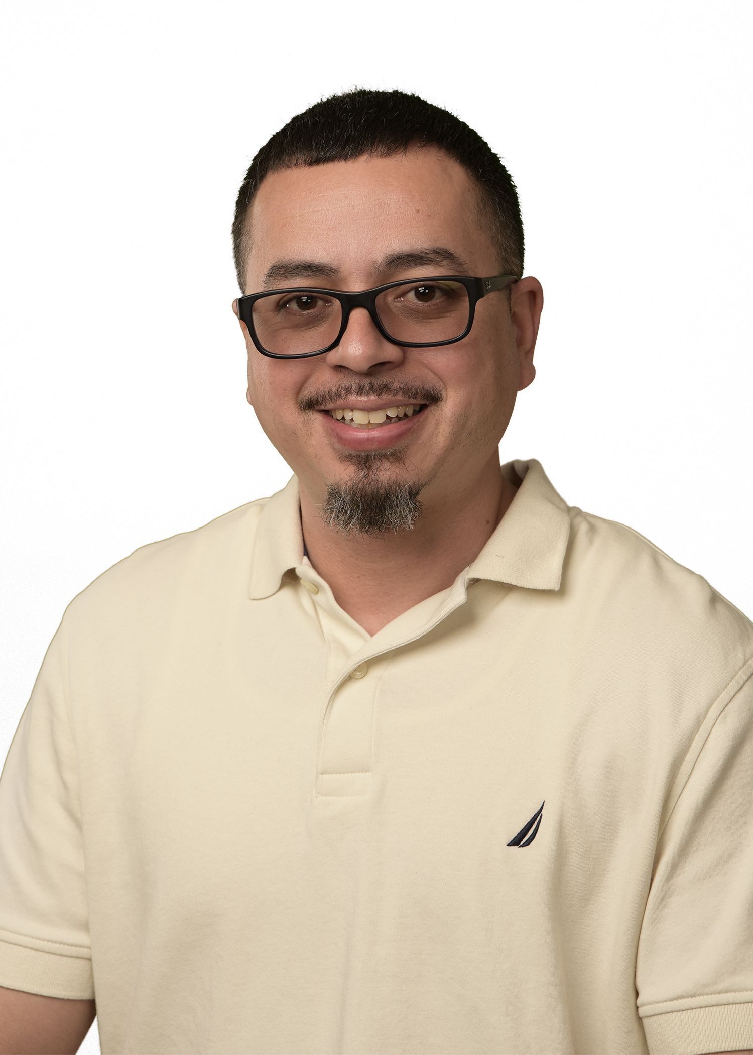 A man wearing glasses and a fuller 's collision center shirt is smiling for the camera.