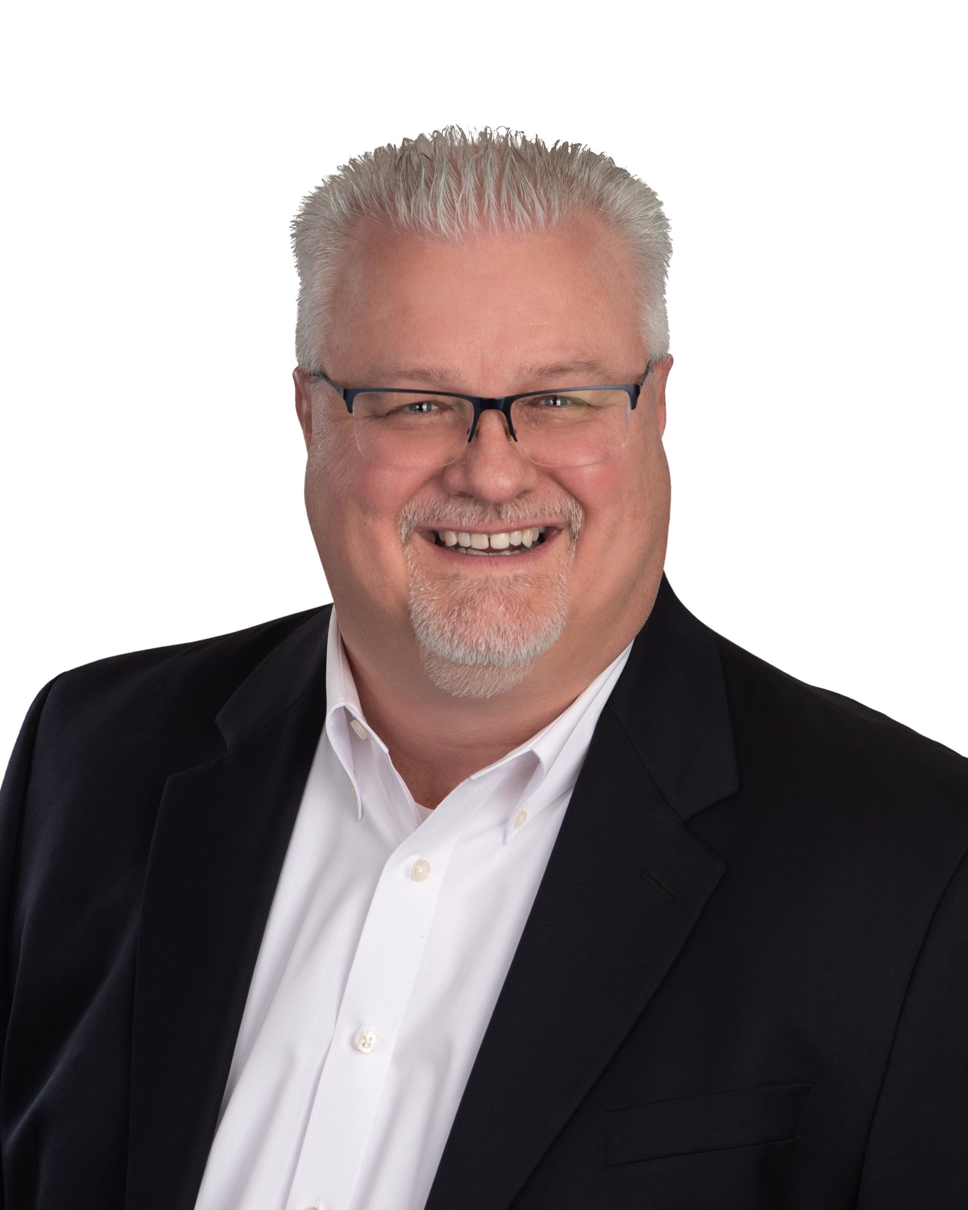 A man wearing a suit and glasses is smiling for the camera.