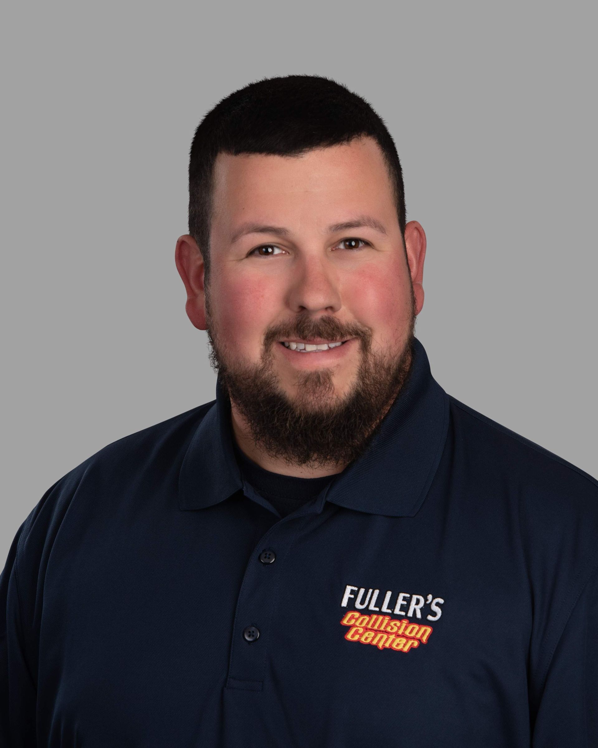 A man with a beard is wearing a blue shirt with the word fuller 's on it.