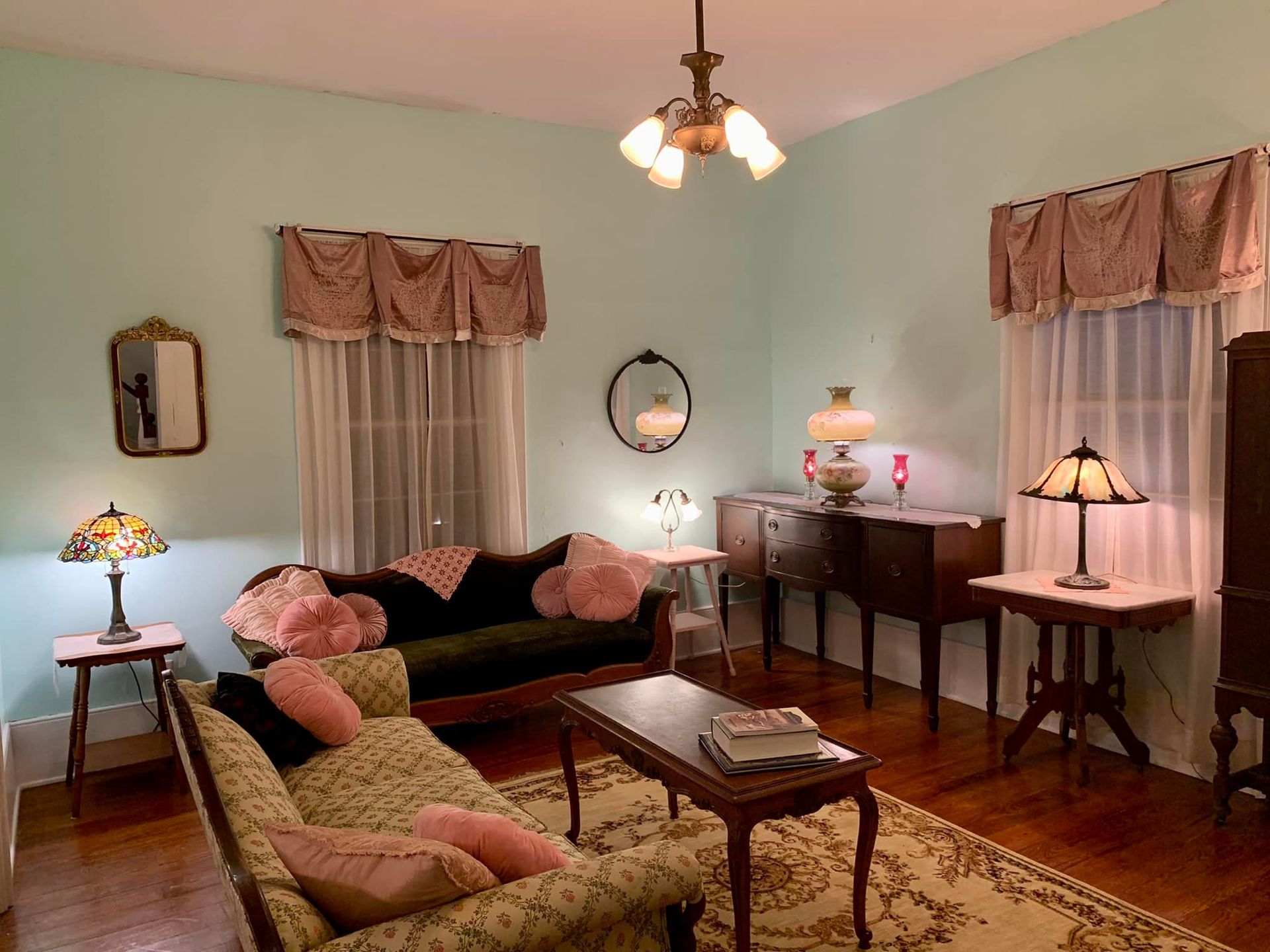 A living room with a couch a table and lamps