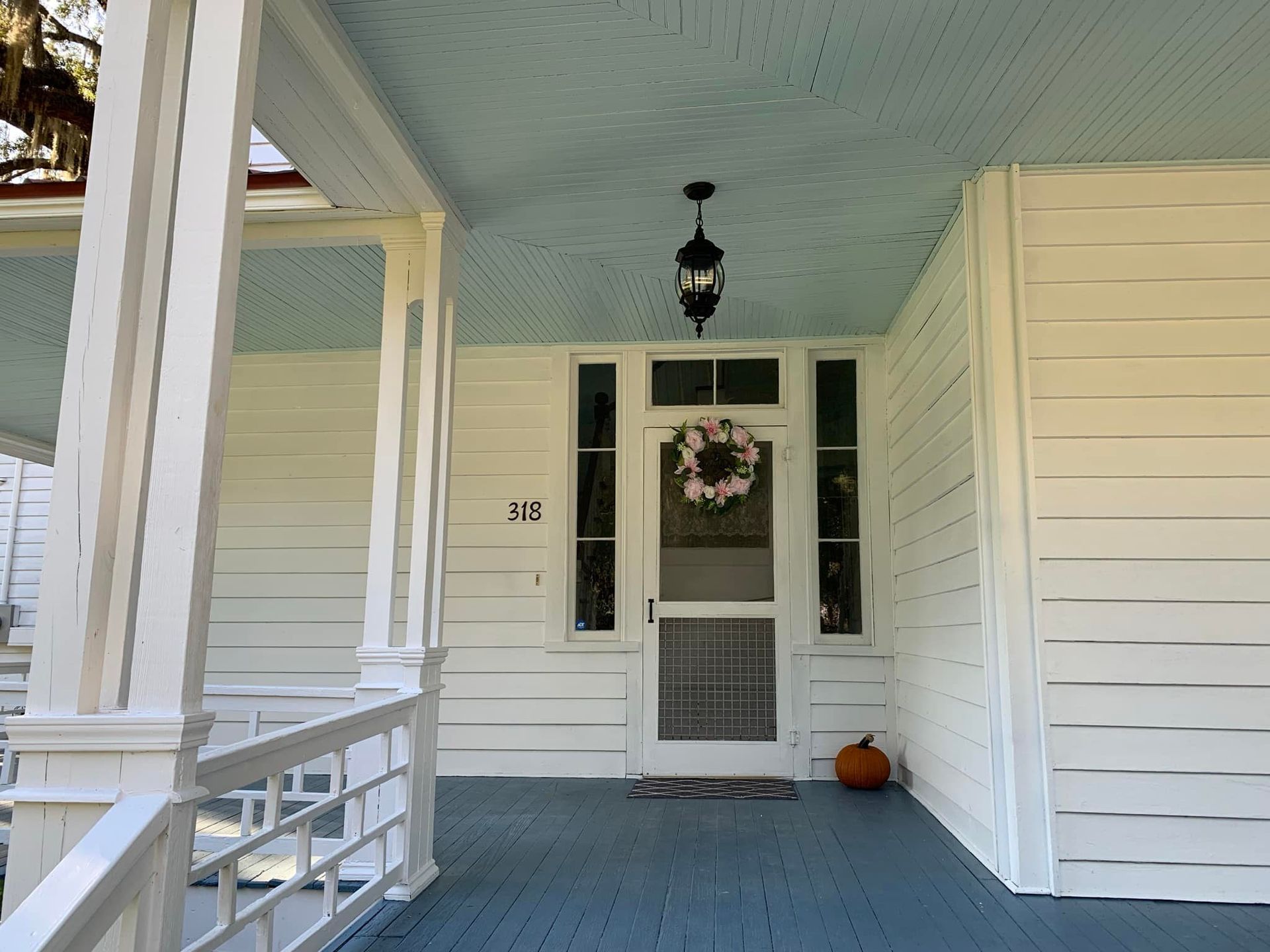 The front porch of a white house.