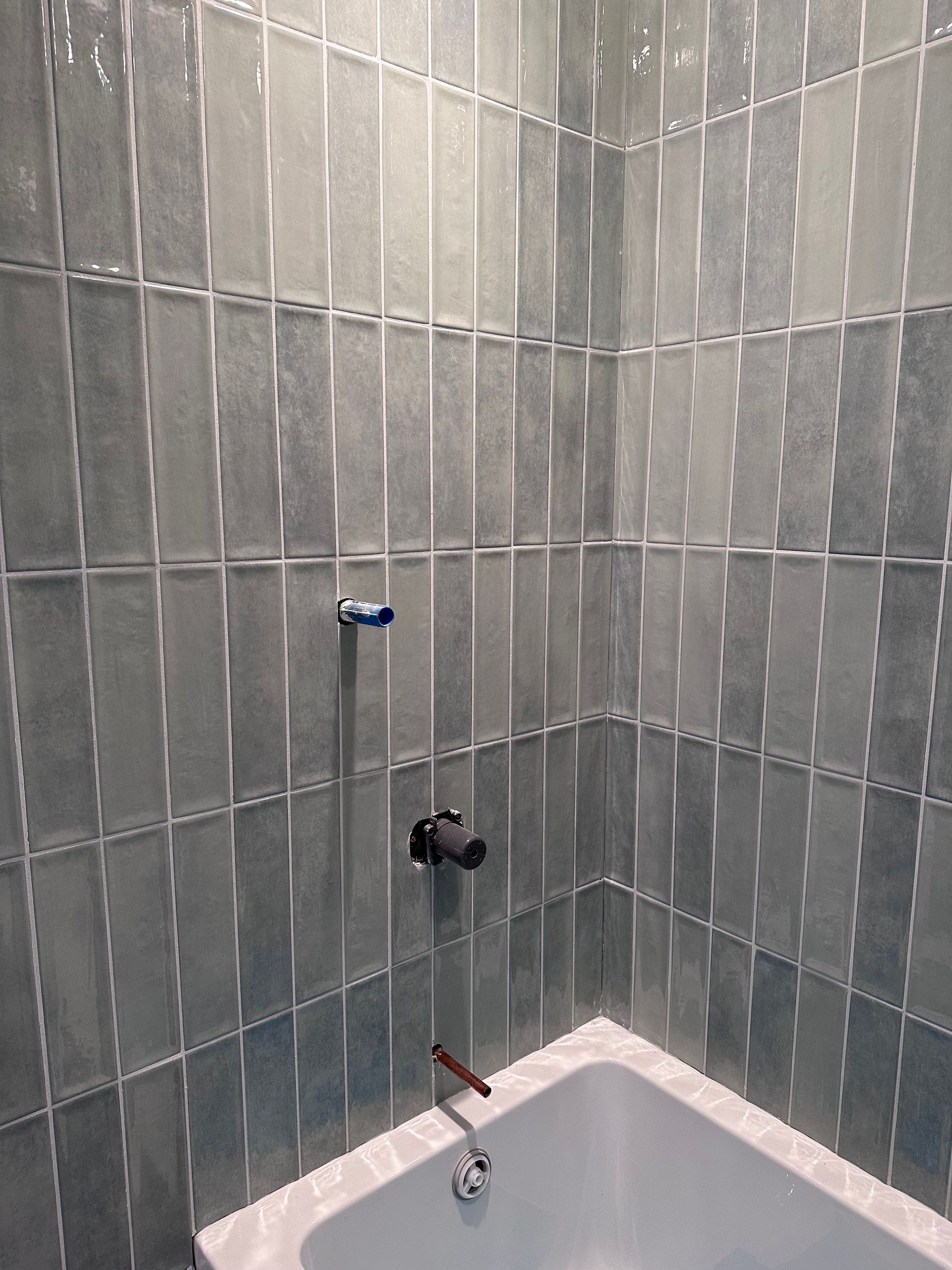 Il y a une baignoire dans le coin de la salle de bain.