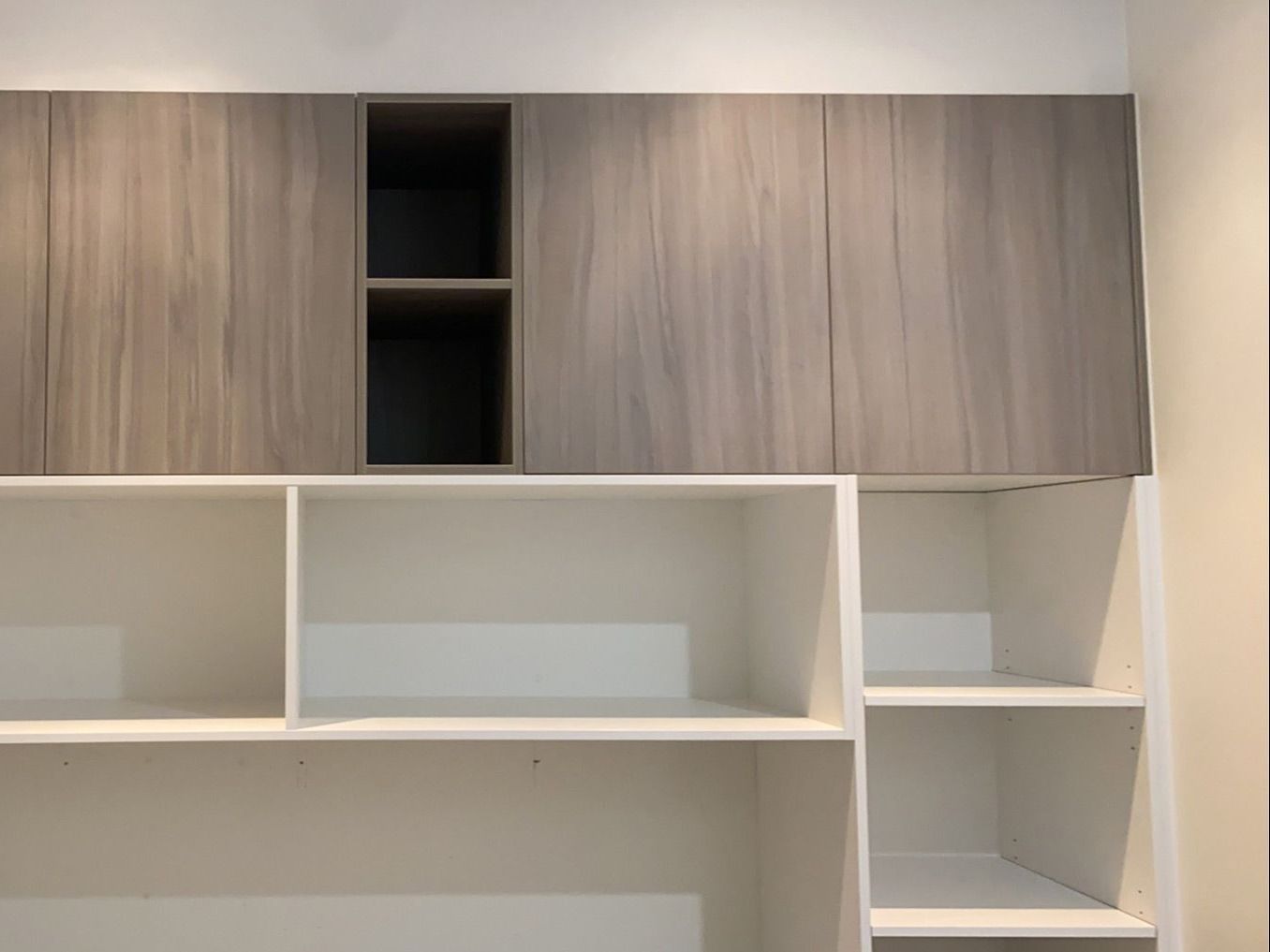 Built-in shelves and cabinets, with gray and white finishes, mounted on the wall. — Cut N Edge Panel Factory In Coolum Beach, QLD