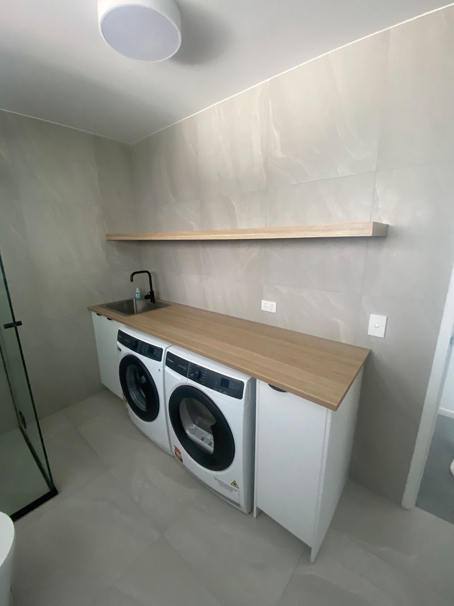 A Laundry Room With A Washer And Dryer And A Sink — Cut N Edge Panel Factory In Coolum Beach, QLD