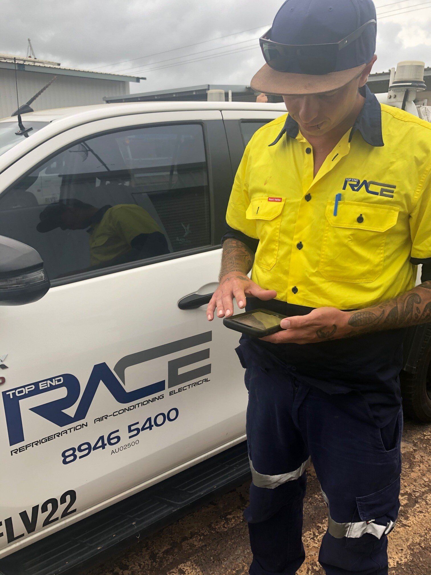 Staff Holding a Cellphone — Holtze, NT — Top End Race