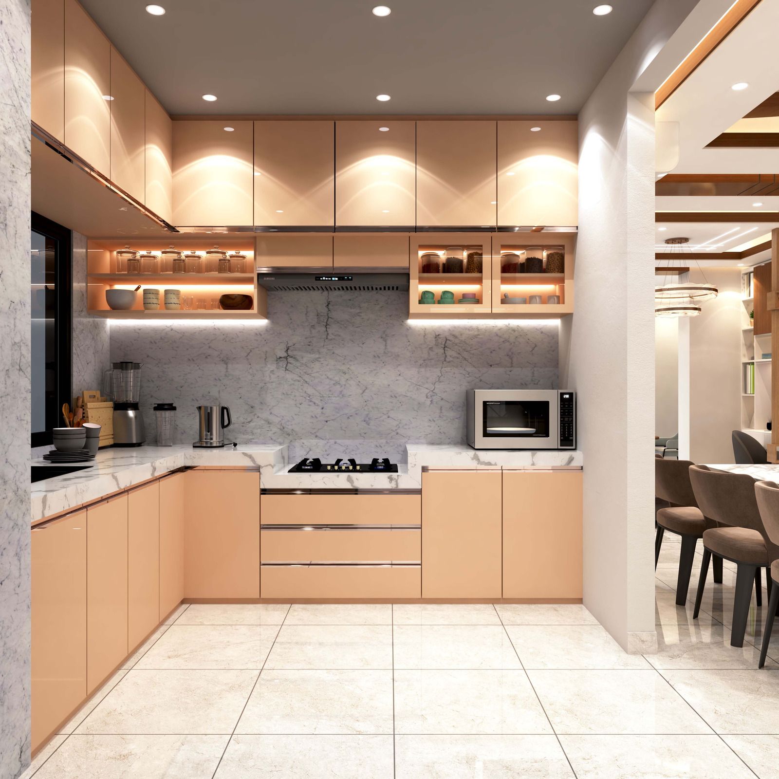 Modern kitchen with soft peach-colored cabinets, marble countertops and backsplash, under-cabinet lighting, and appliances.