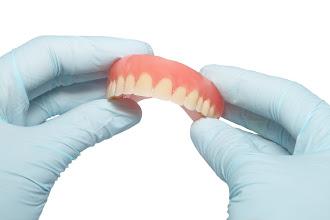 Dentist Holding Dentures — Sarasota, FL — Gregory S. Rutherford, DDS, PA