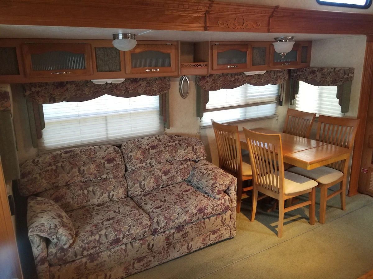 A living room with a couch and a table and chairs