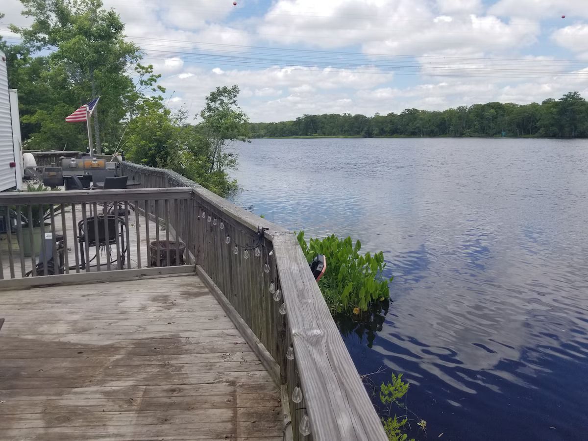 A wooden deck overlooking a large body of water.