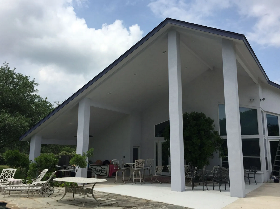 A large white house with a blue roof built by Fine Patio Design San Antonio TX