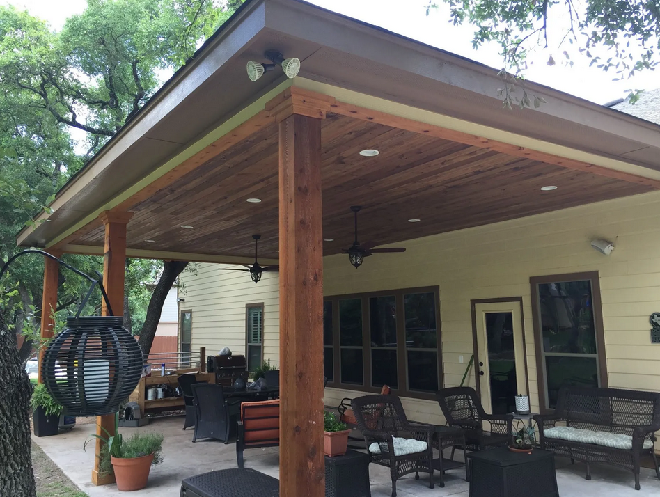 A house with a covered patio with a ceiling fan built by Fine Patio Design San Antonio TX