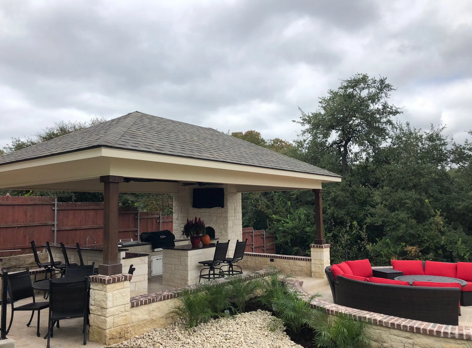 A patio area with a gazebo and a red couch built by Fine Patio Design San Antonio TX