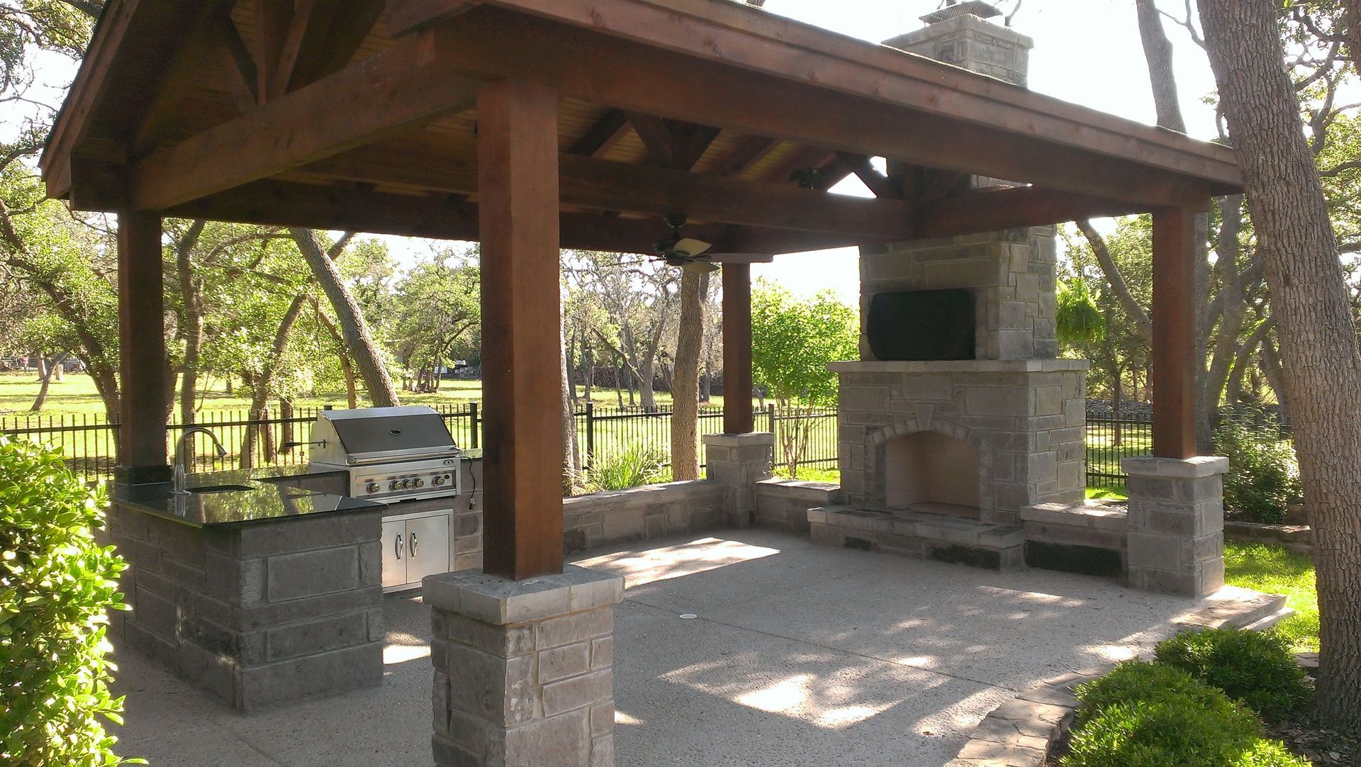 A gazebo with a grill and fireplace underneath it built by Fine Patio Design San Antonio TX