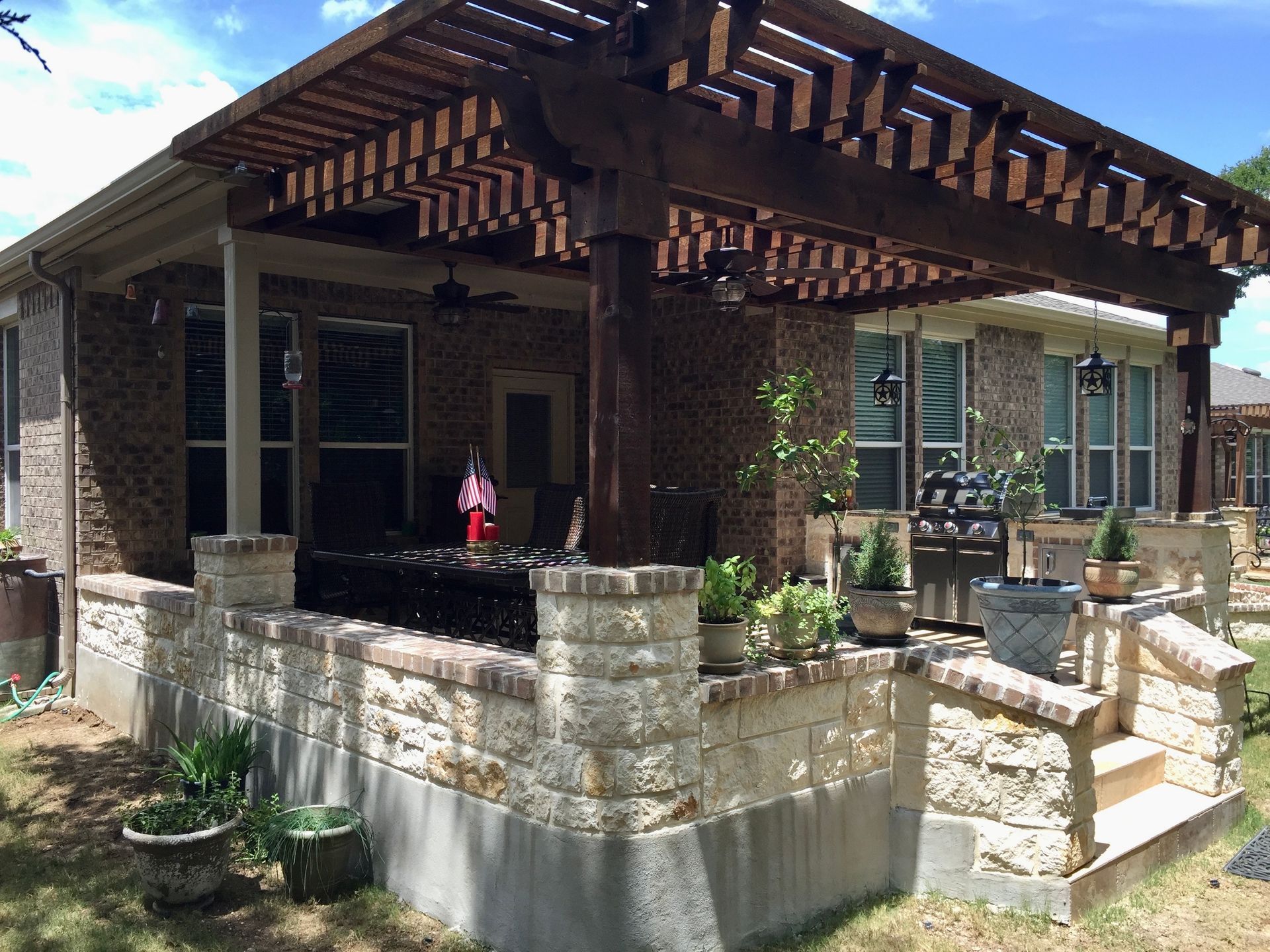 A house with a wooden pergola on top of it built by Fine Patio Design San Antonio TX