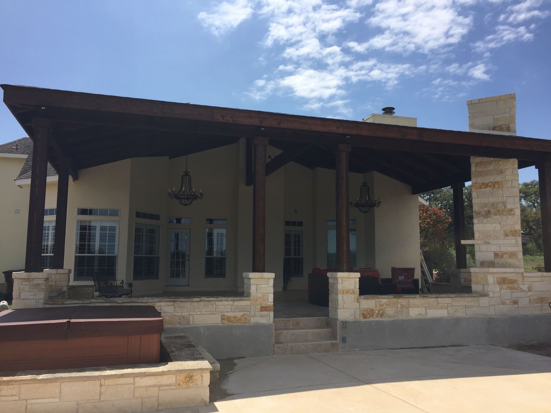 A house with a covered porch and stairs built by Fine Patio Design San Antonio TX