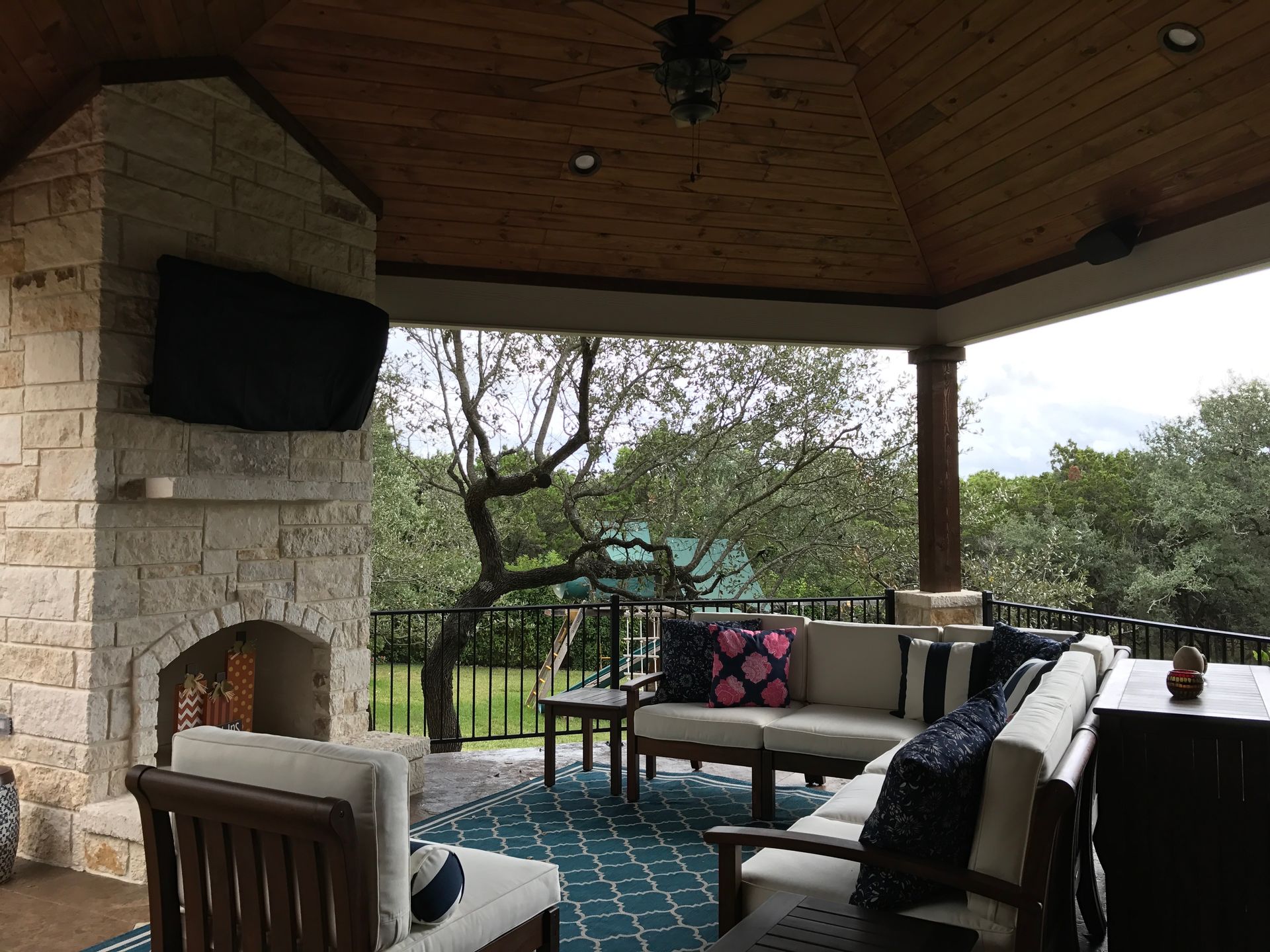 A living room with a fireplace and a flat screen tv built by Fine Patio Design San Antonio TX