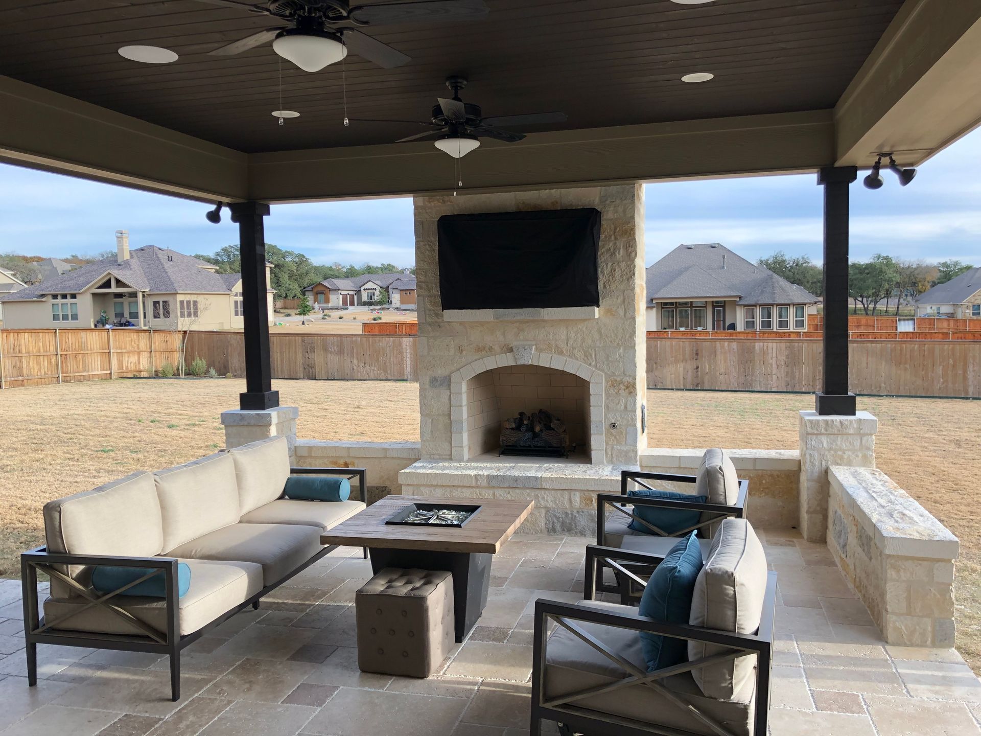 A living room with a fireplace and a flat screen tv built by Fine Patio Design San Antonio TX