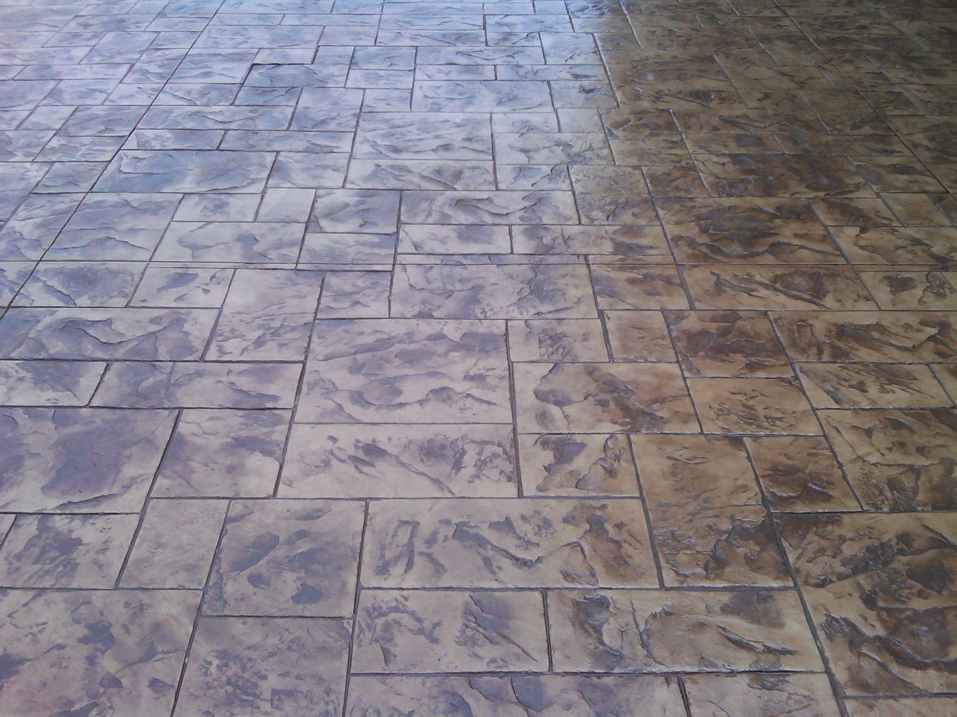 A decorative concrete floor with a few spots of paint on it built by Fine Patio Design San Antonio TX