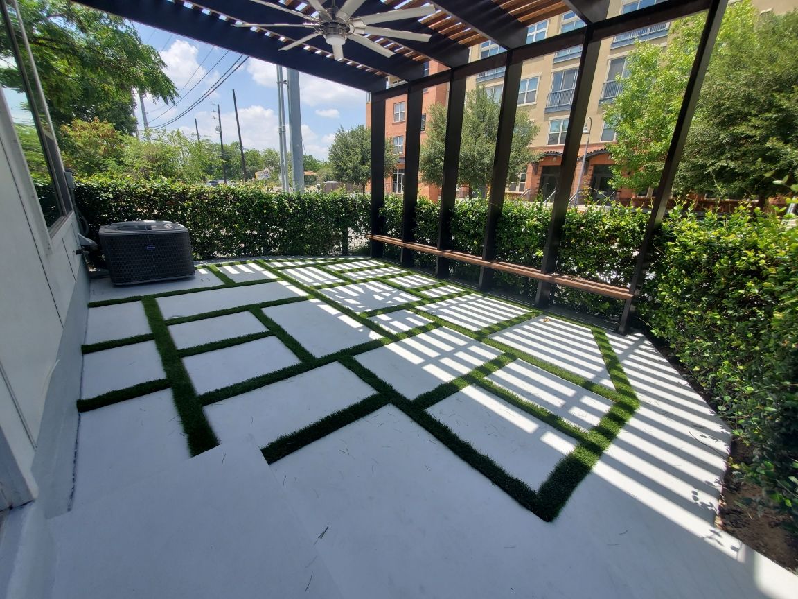 A patio with a pergola and a ceiling fan built by Fine Patio Design San Antonio TX