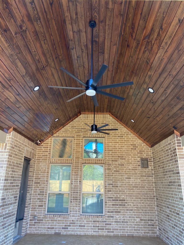 A ceiling fan is hanging from the ceiling of a brick building built by Fine Patio Design San Antonio TX