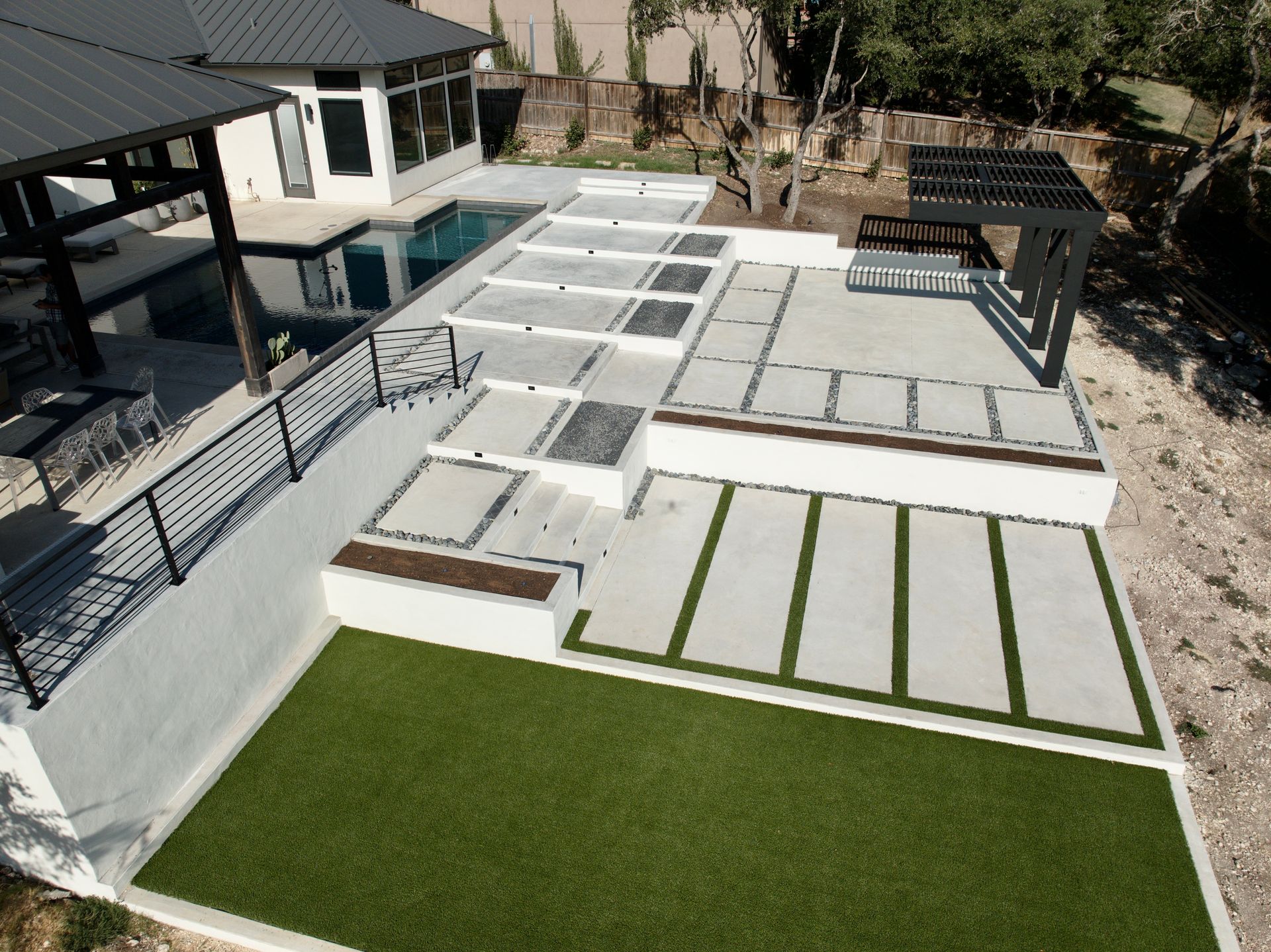 An aerial view of a house with a swimming pool built by Fine Patio Design San Antonio TX