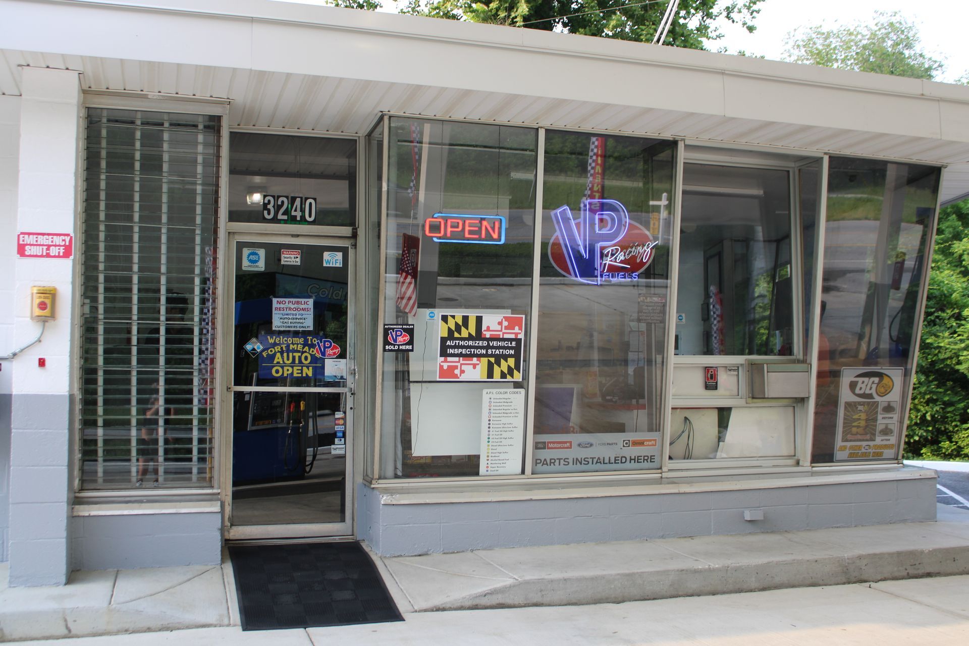 Small store with glass windows and door; neon