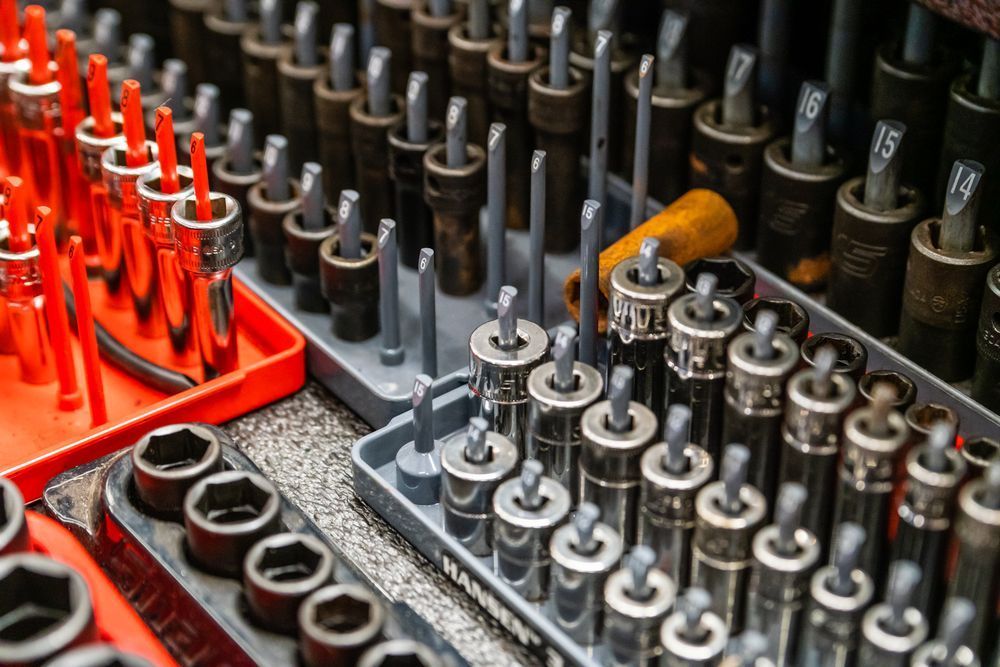 Toolbox organized with sockets, wrenches, and extensions in red, gray, and black. | Fort Meade Auto Center