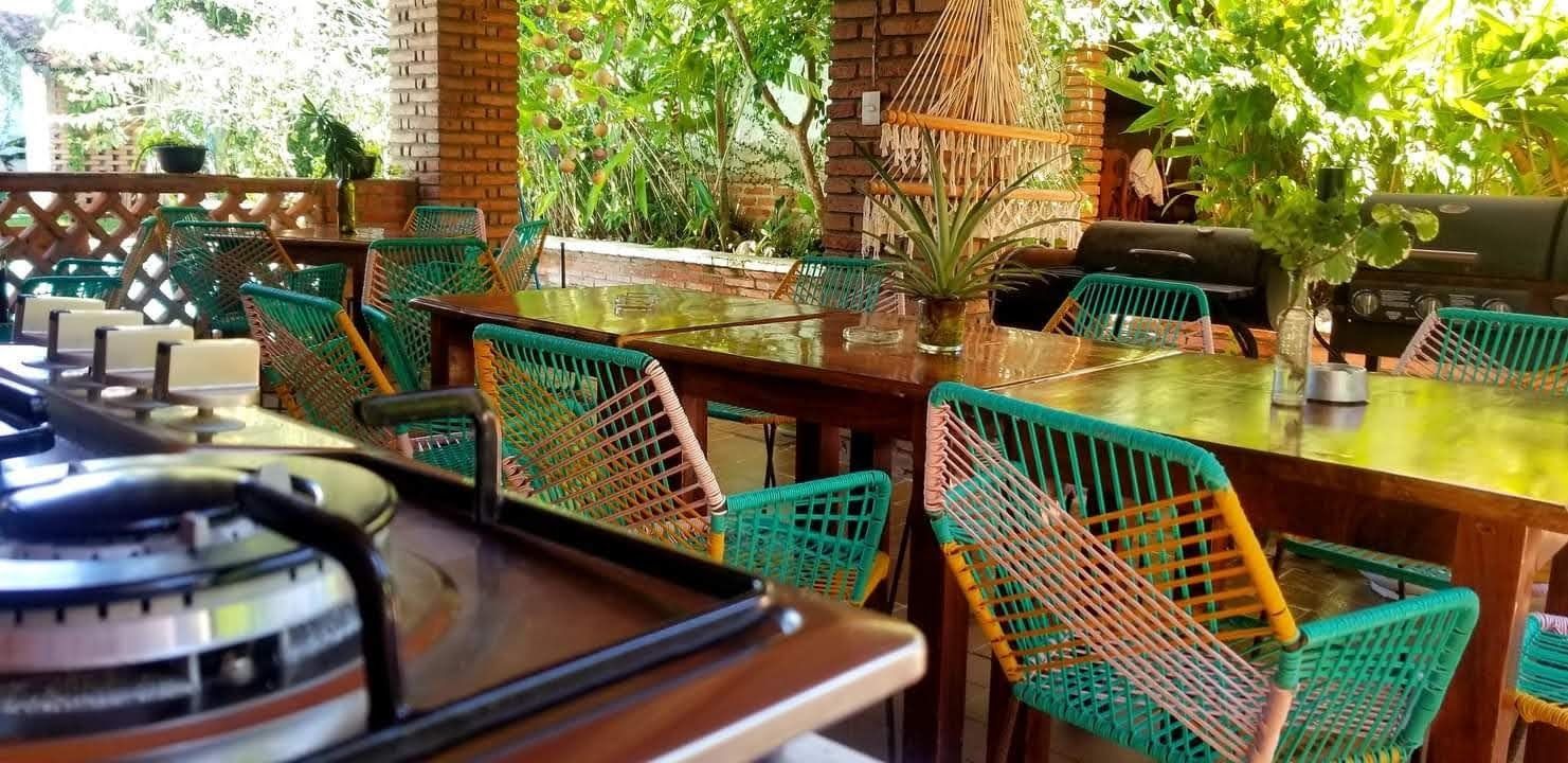 A stove top oven is sitting on top of a wooden table in a restaurant.