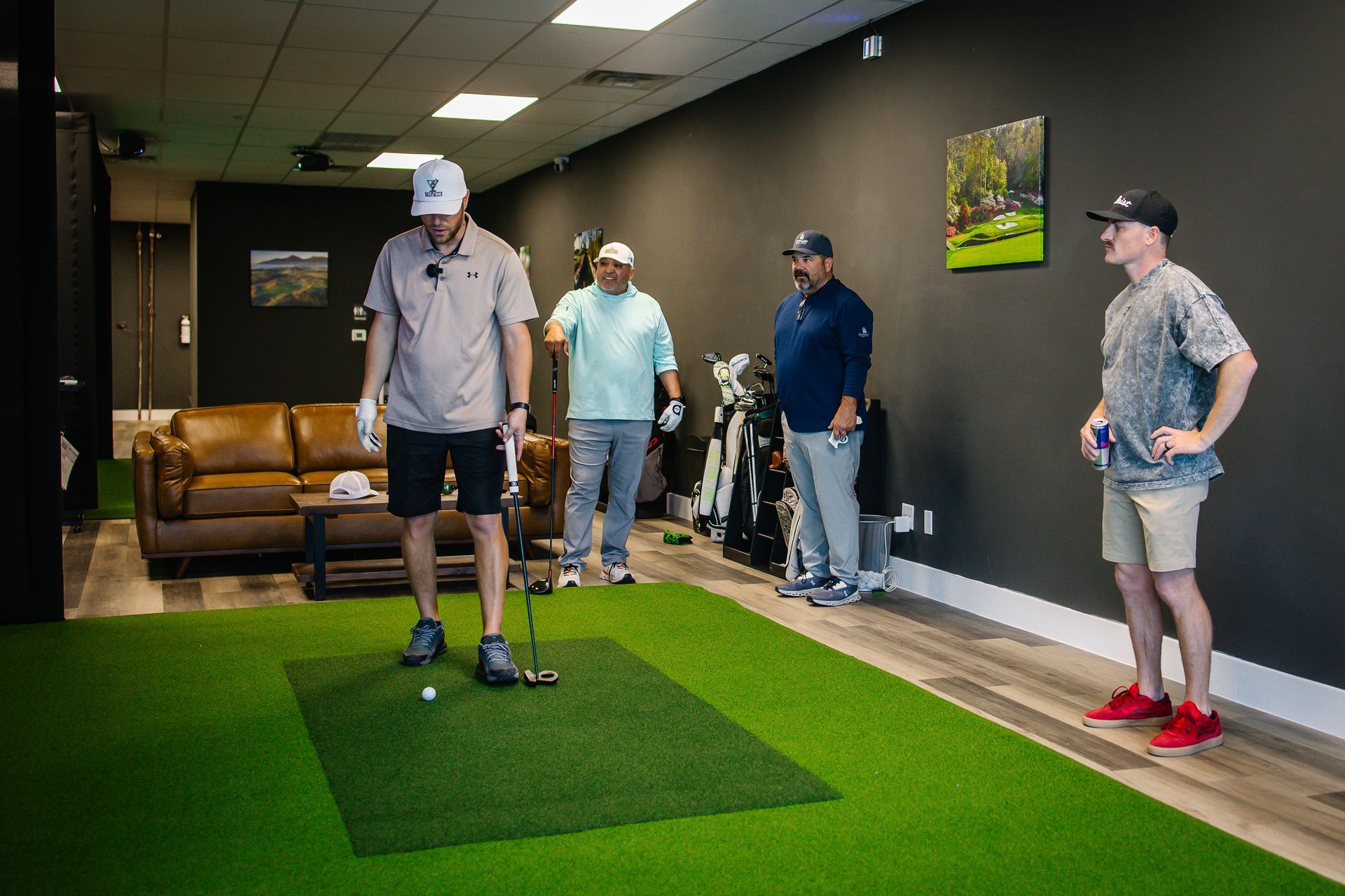 A group of men are playing golf in a living room.