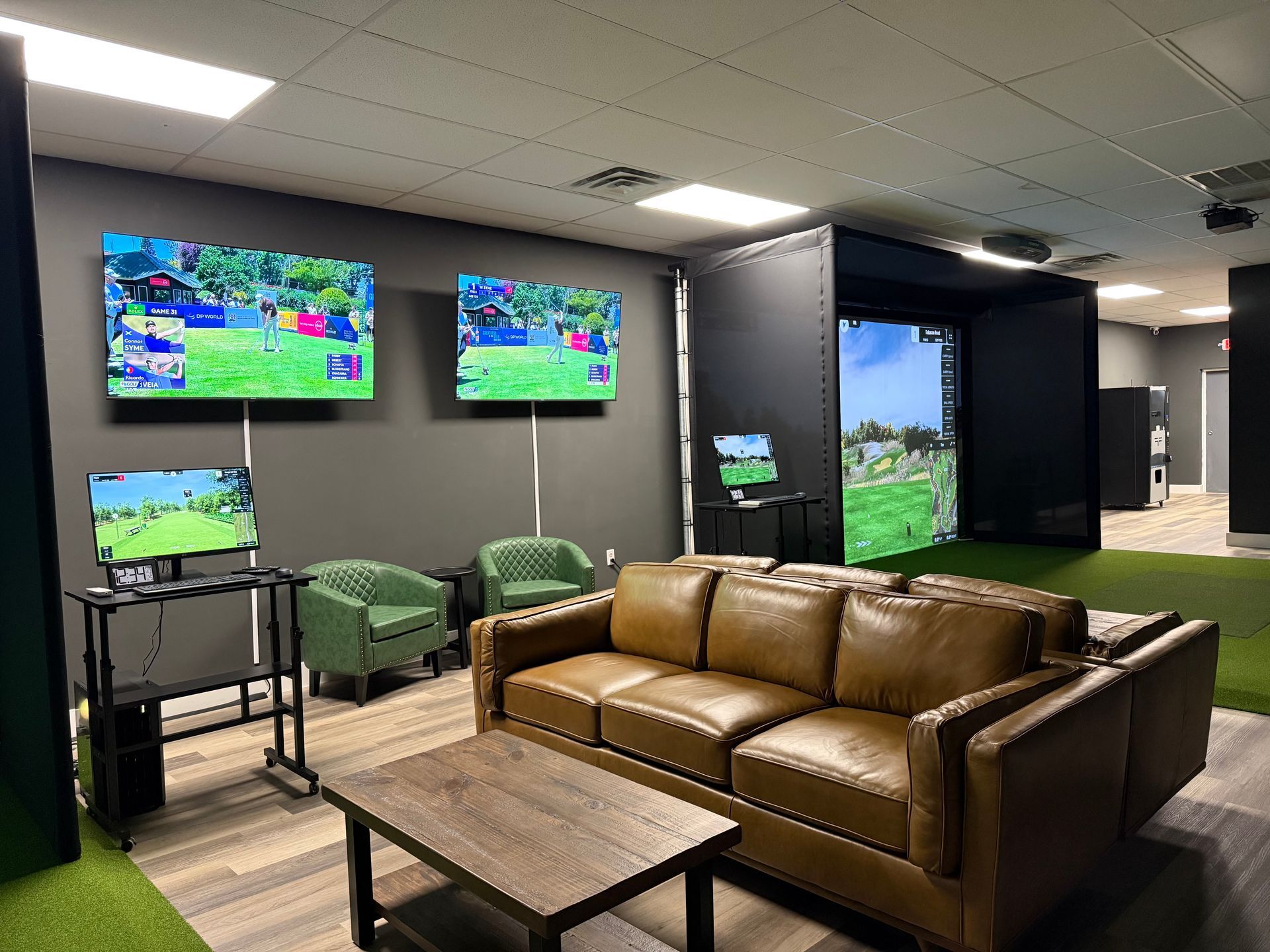 A living room with a couch , chairs , and two televisions.