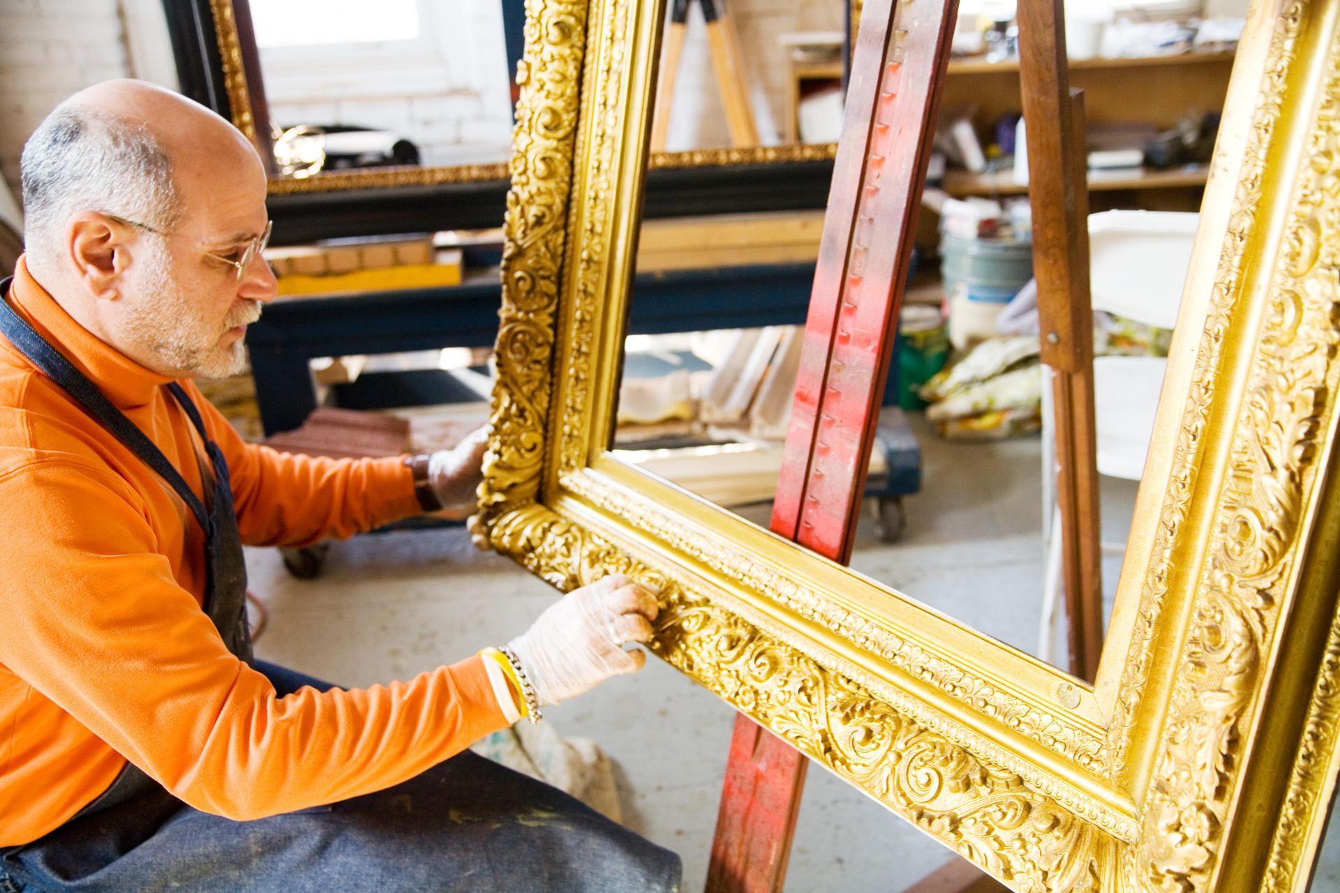 Man Cleaning A Frame Of A Painting | Wichita, KS | The Frame Guild