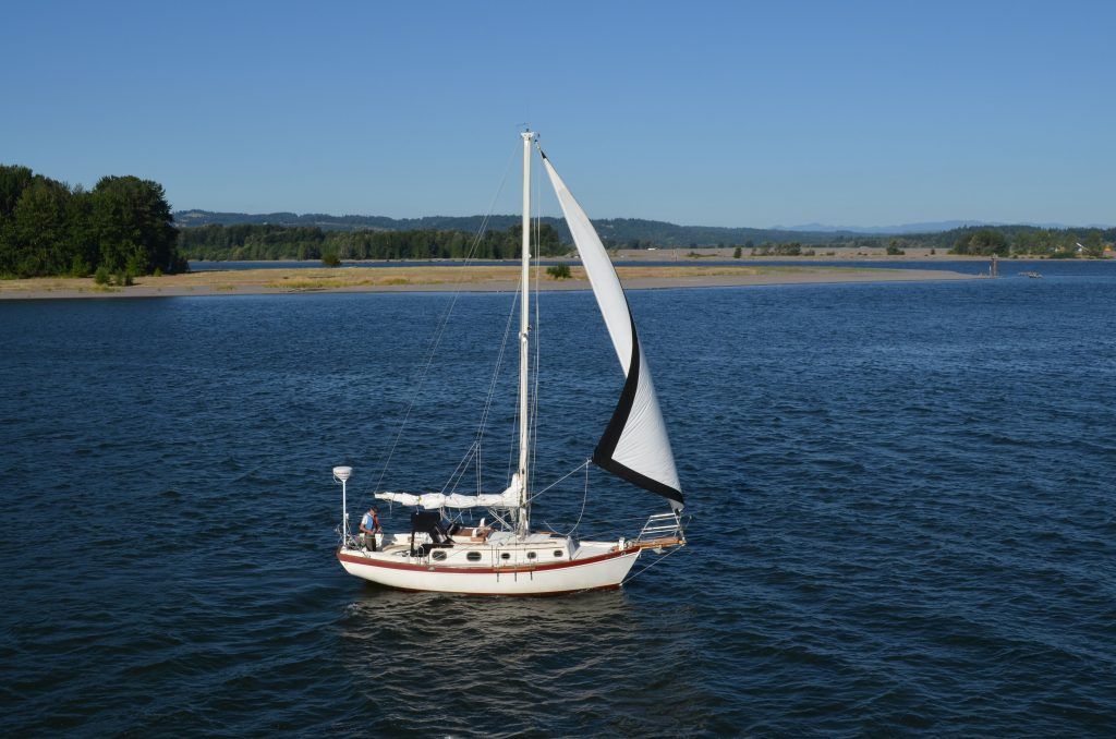 A sailboat is floating on a large body of water