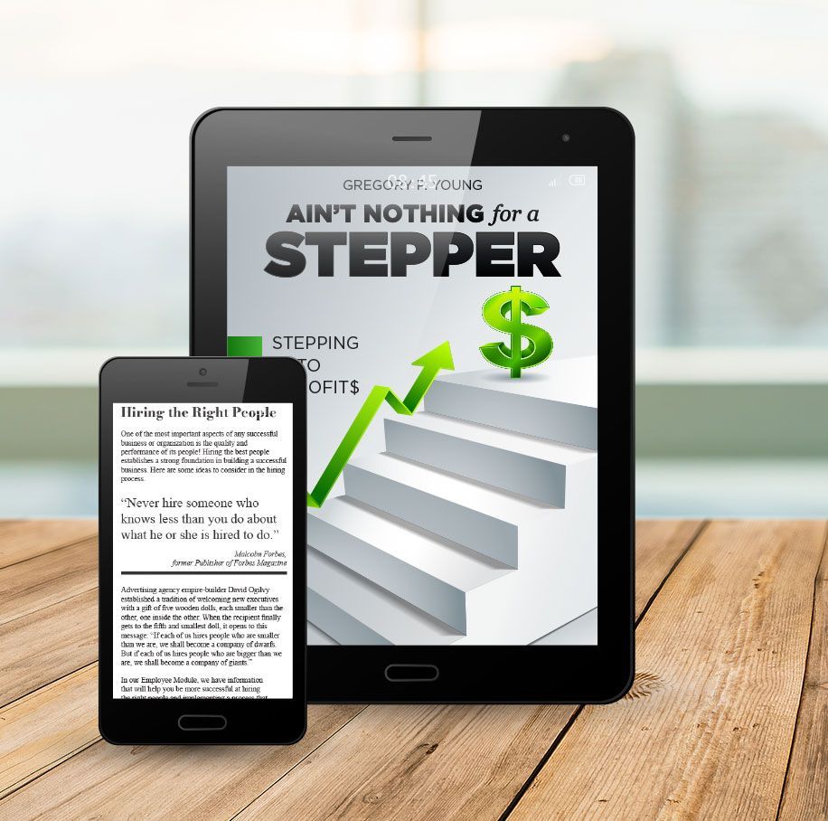 A tablet and a cell phone are sitting on a wooden table.