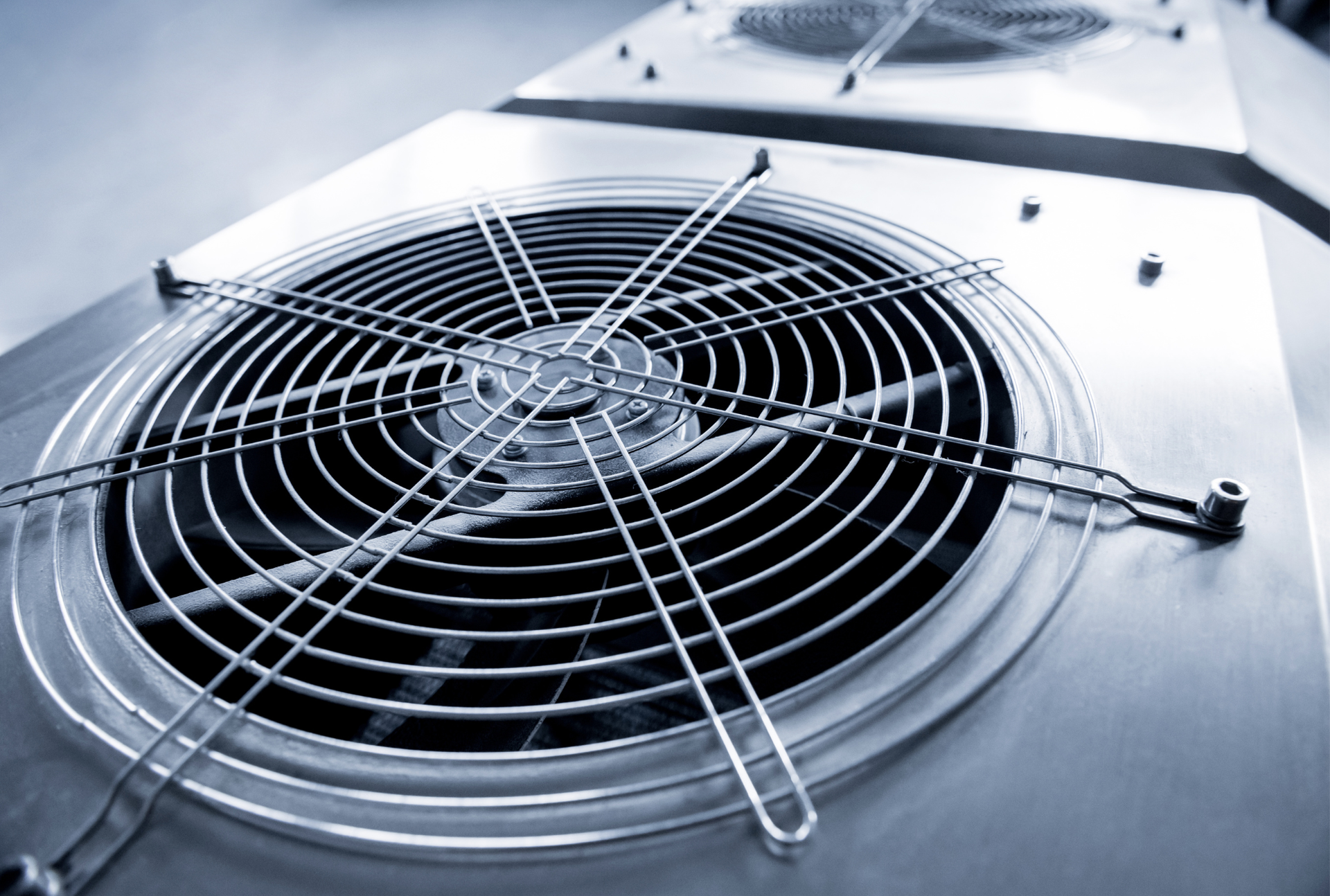 A close up of a fan on top of a building.