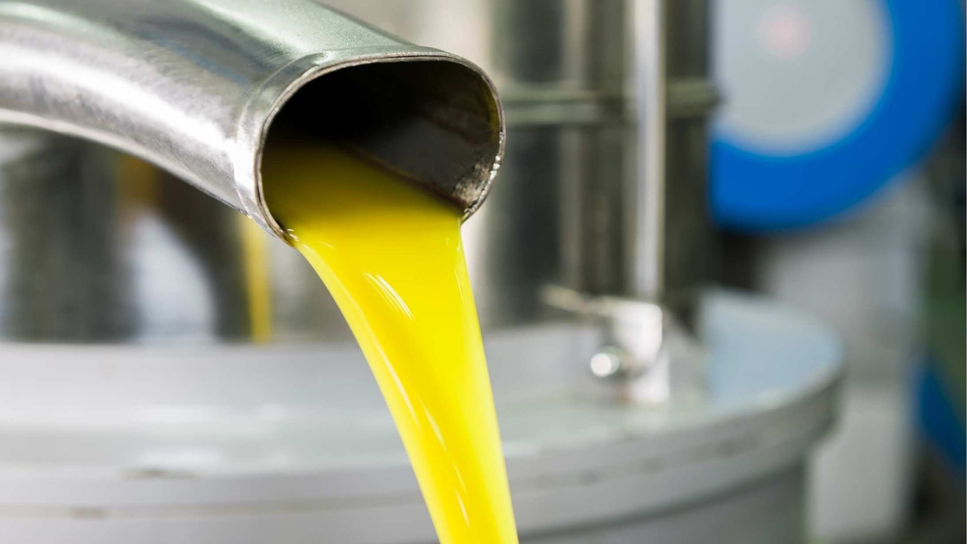 A close up of a pipe pouring liquid into a container.