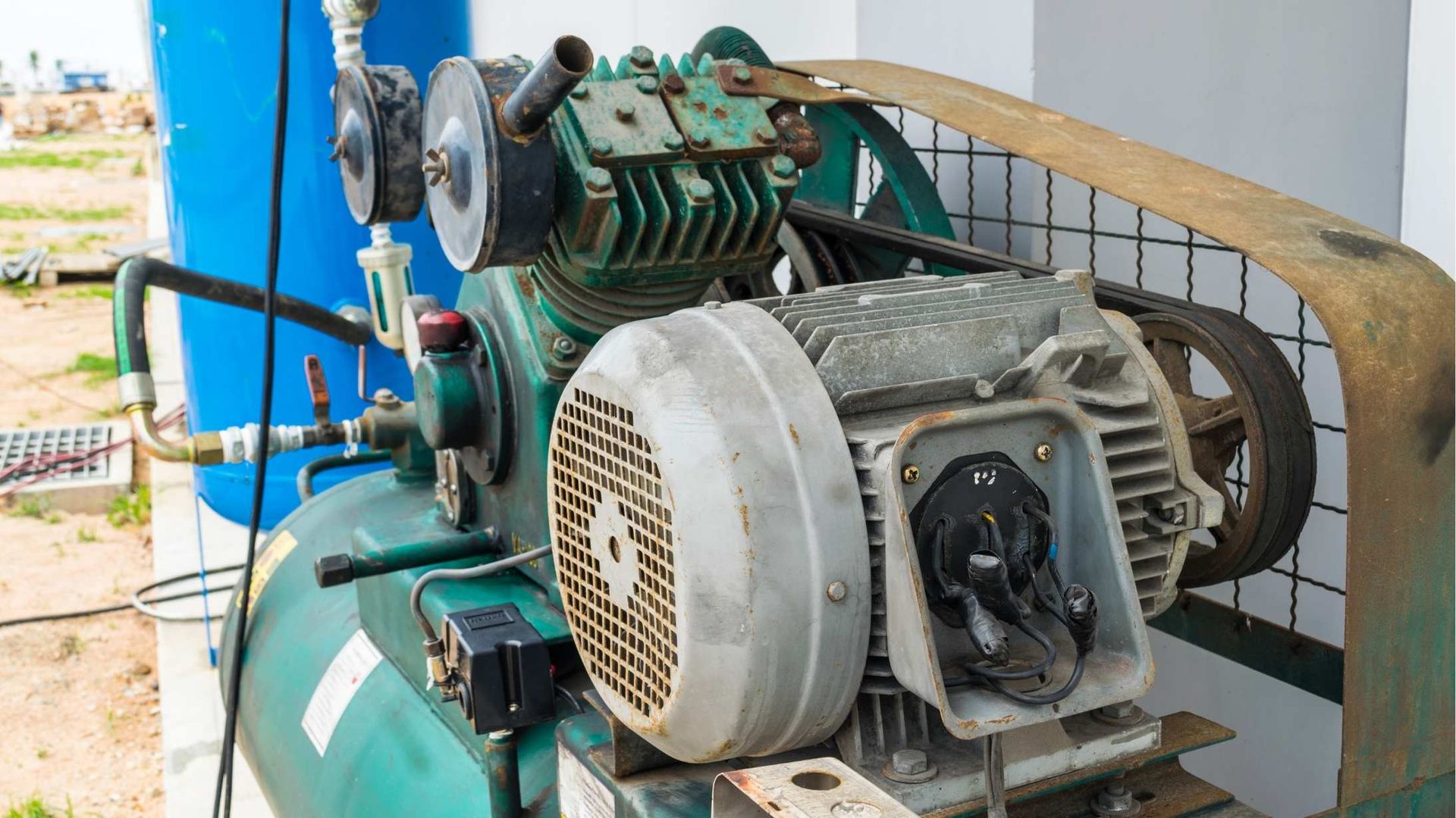 A close up of an air compressor with a fan attached to it.